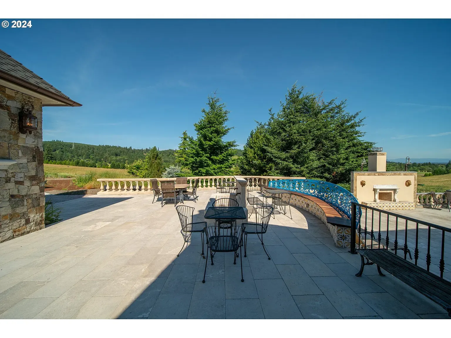Another patio, light stone everywhere. Those blue accents pop. Great sunset hang spot.