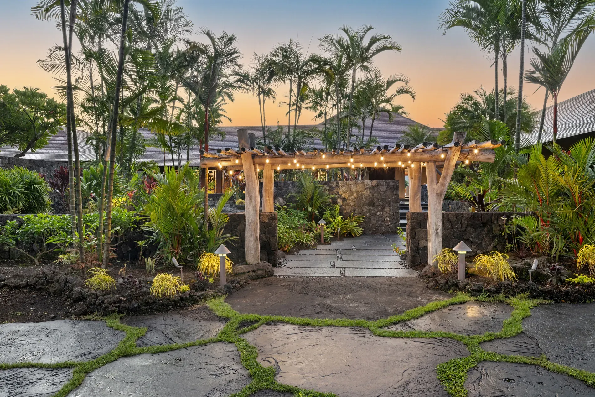 String-lit pergola over a quirky stone path — feels cozy instantly.
