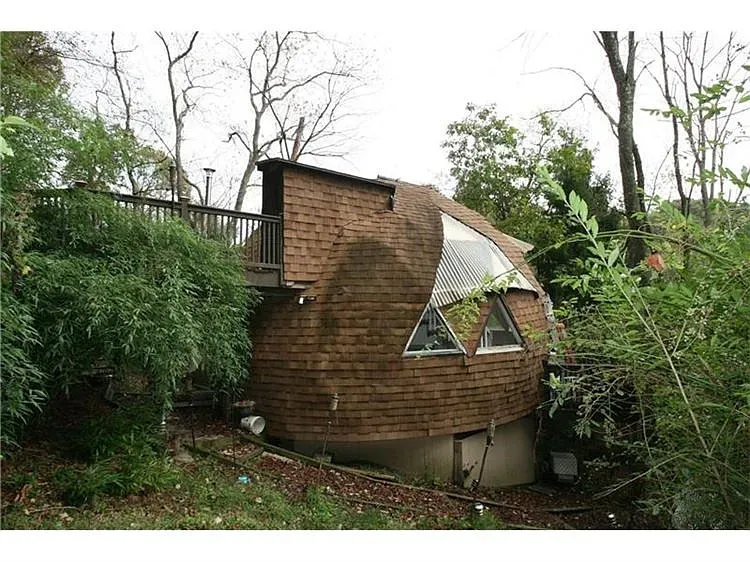 Here's the A-frame—shingles for days. Looks cozy, kind of cabin-chic.
