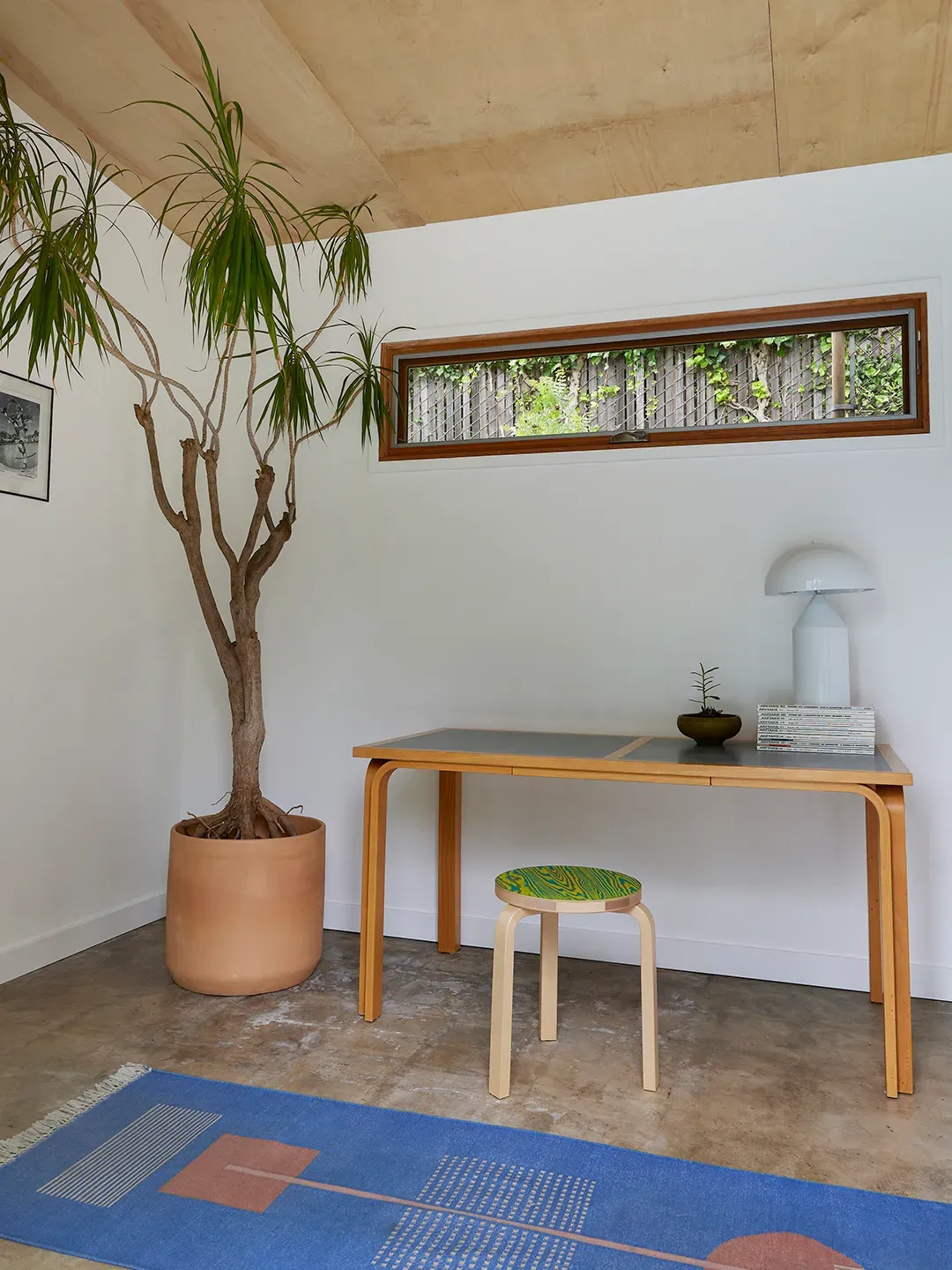 Inside. white walls, wood ceiling, simple furniture. Calm but not cold.