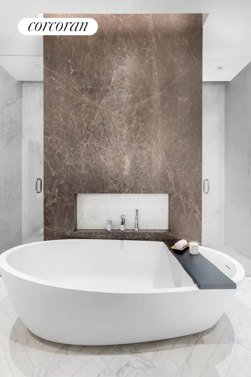 Freestanding tub, dramatic dark marble wall. Anyone know why they did this?