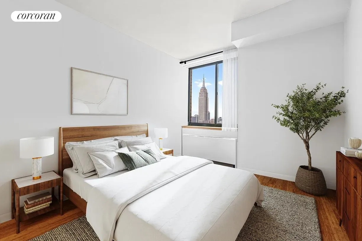 Here’s the calm bedroom — soft white, big window, skyline framed art.