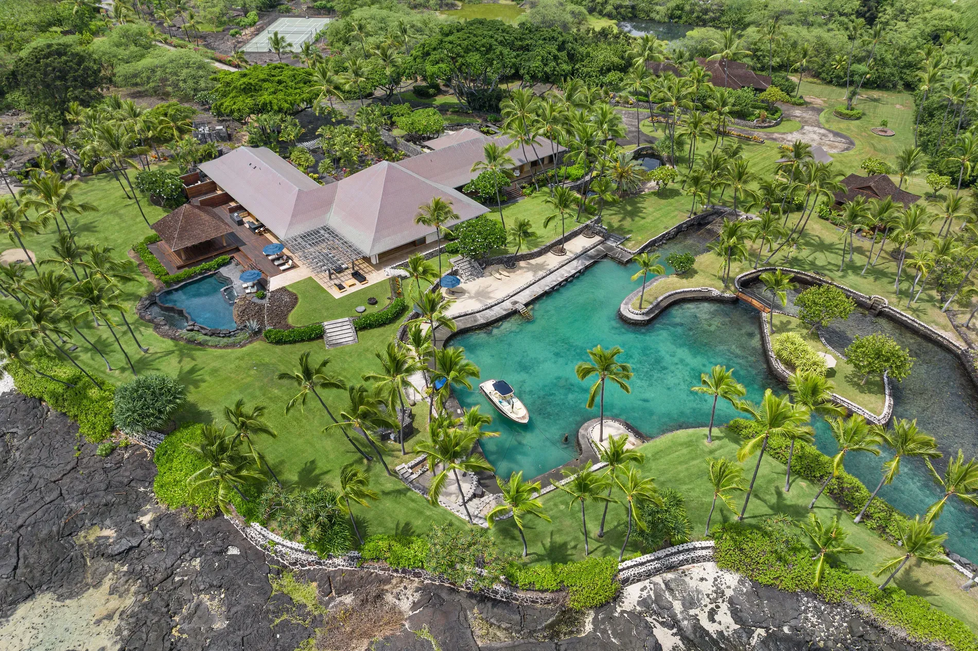 And here's the aerial — sloped roofs, glass everywhere, nestled in green.