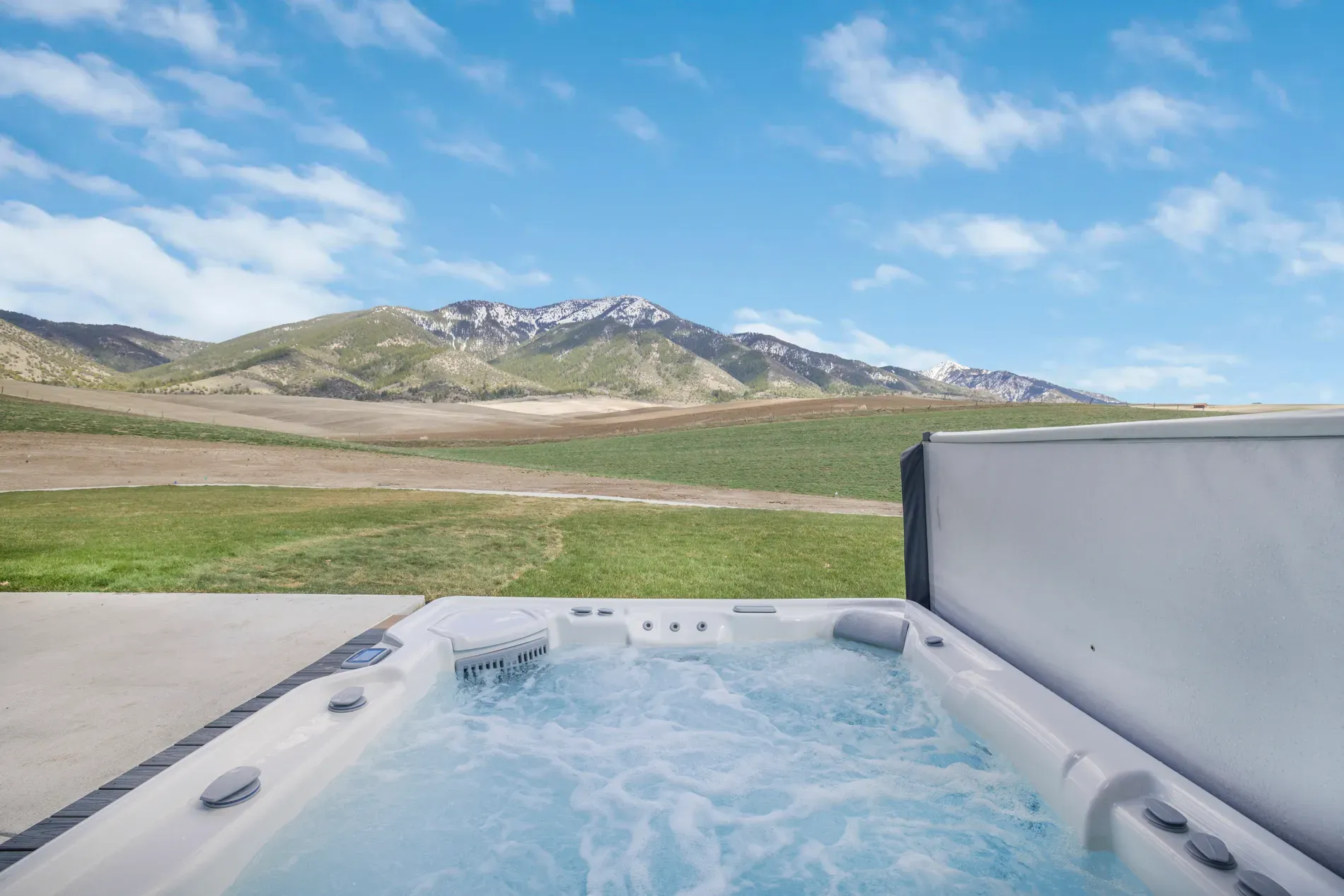 Back outside to the hot tub — that view is ridiculous. Steam, mountains.