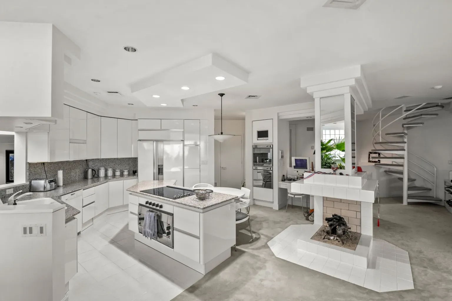 Here's the kitchen — glossy white everywhere. I mean, do you cook here?