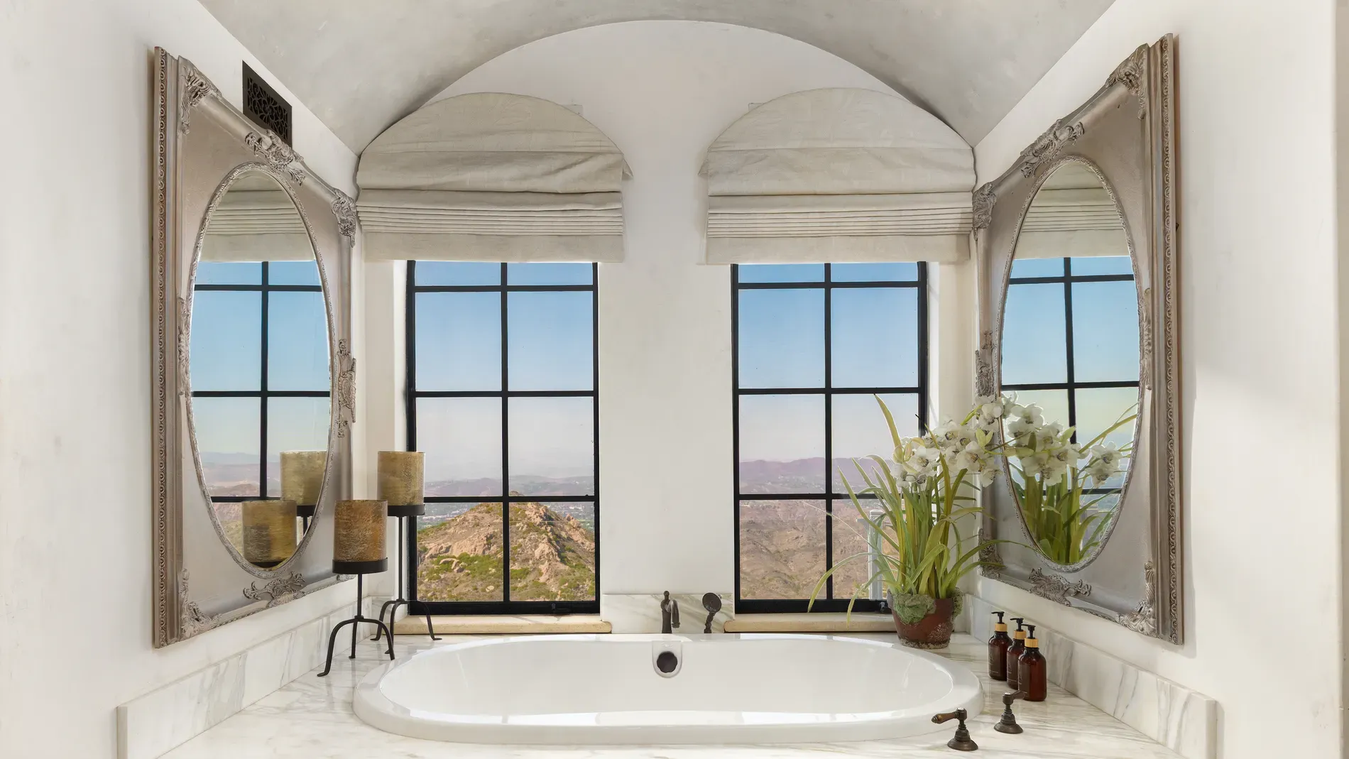 Bathroom with mountain windows and an arched ceiling—quiet, airy, kind of dreamy.