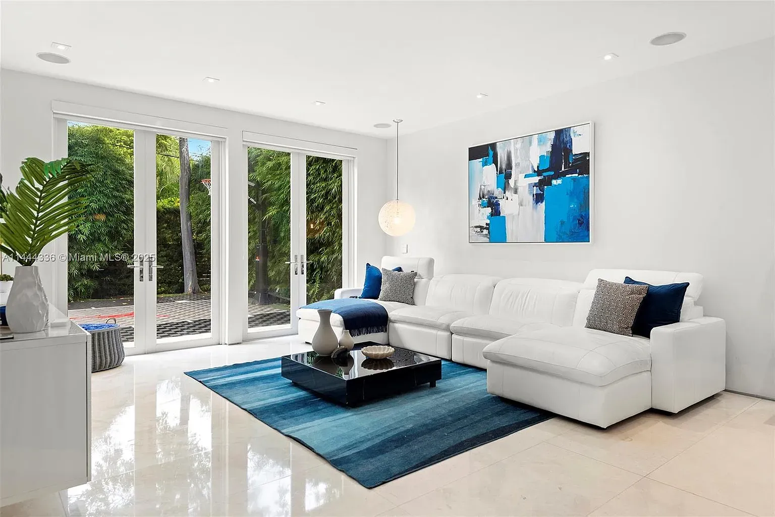 White-on-white living room. Not sure—sleek or sterile? Needs a plant.