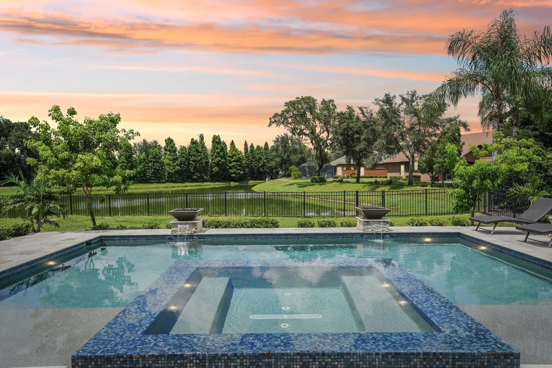 Pool glows with mosaic blues. from this angle, the spa bubbles steal attention.