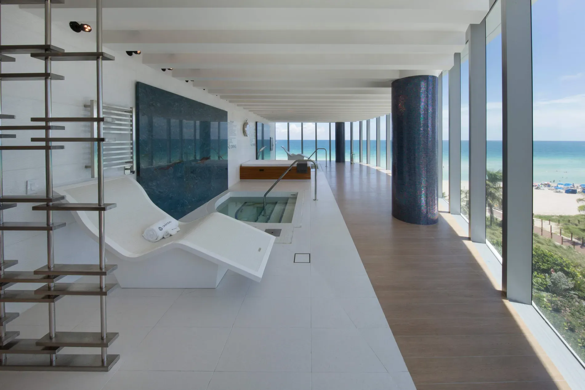 Spa room with wall-to-wall ocean. Calm colors, instant exhale.