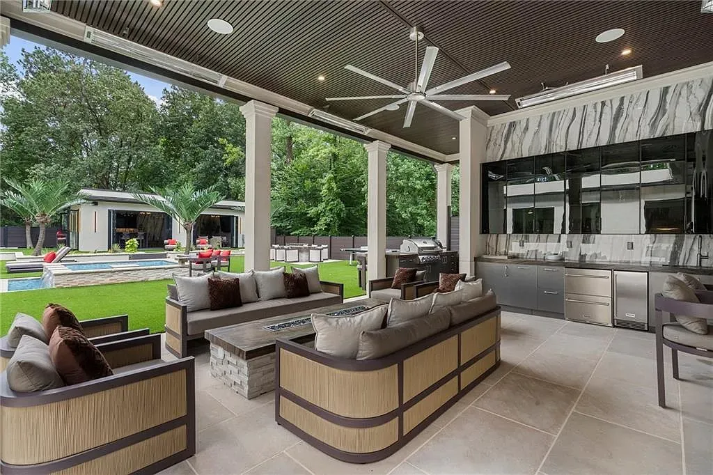 Outdoor lounge under a coffered ceiling. Dark wood overhead makes it feel grounded.