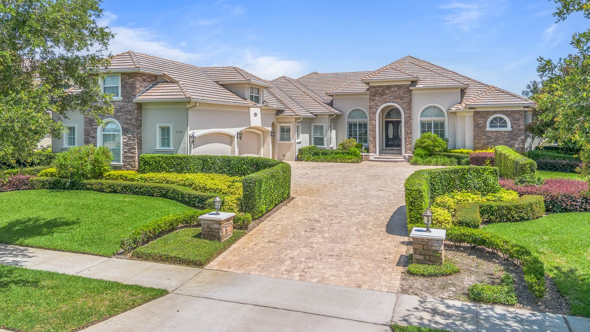 Here's the exterior—stucco and stone, fancy tile roof. Big, but warm.