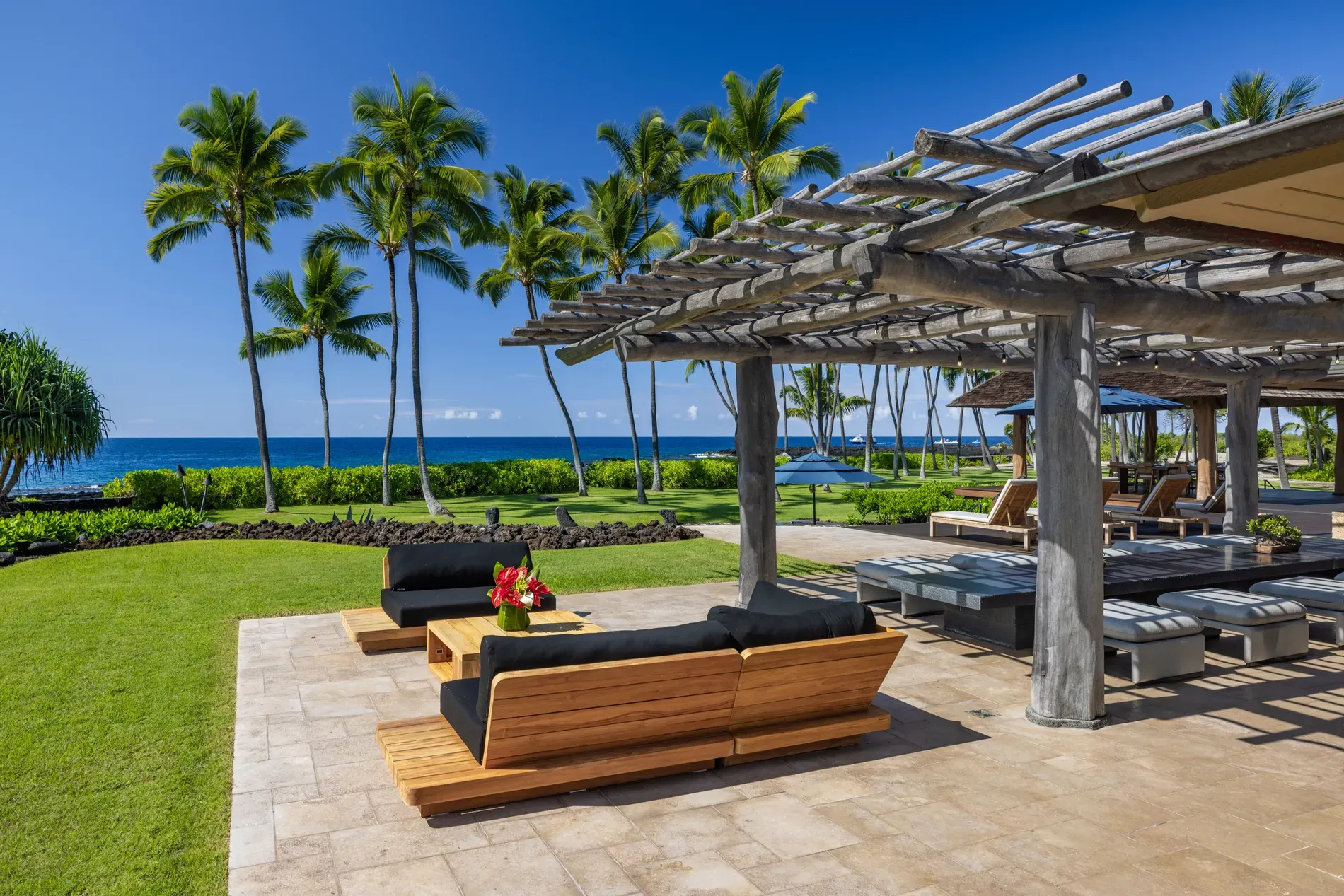 Lounge setup with black cushions, ocean dead ahead. this angle sells it.