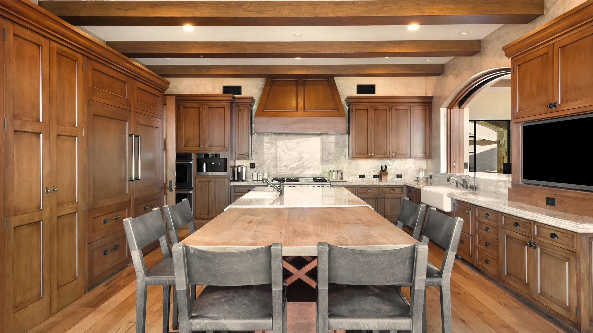 Here's the kitchen—massive reclaimed table stealing the show. Would you cook here?