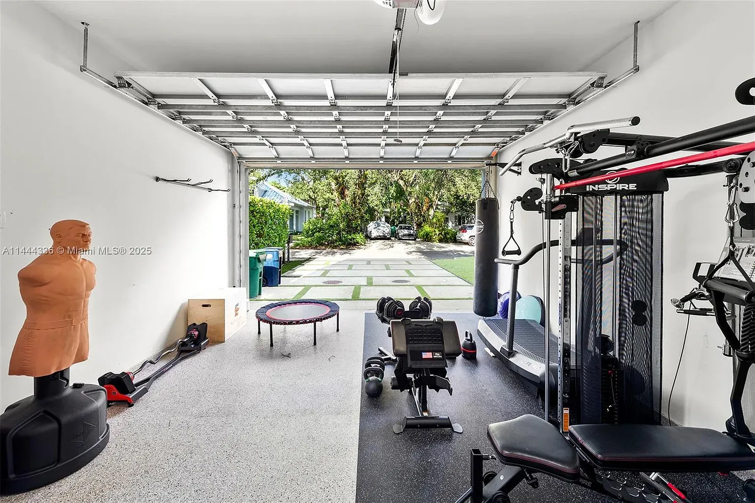 And then a garage gym glow-up. epoxy floor, racks lined up.