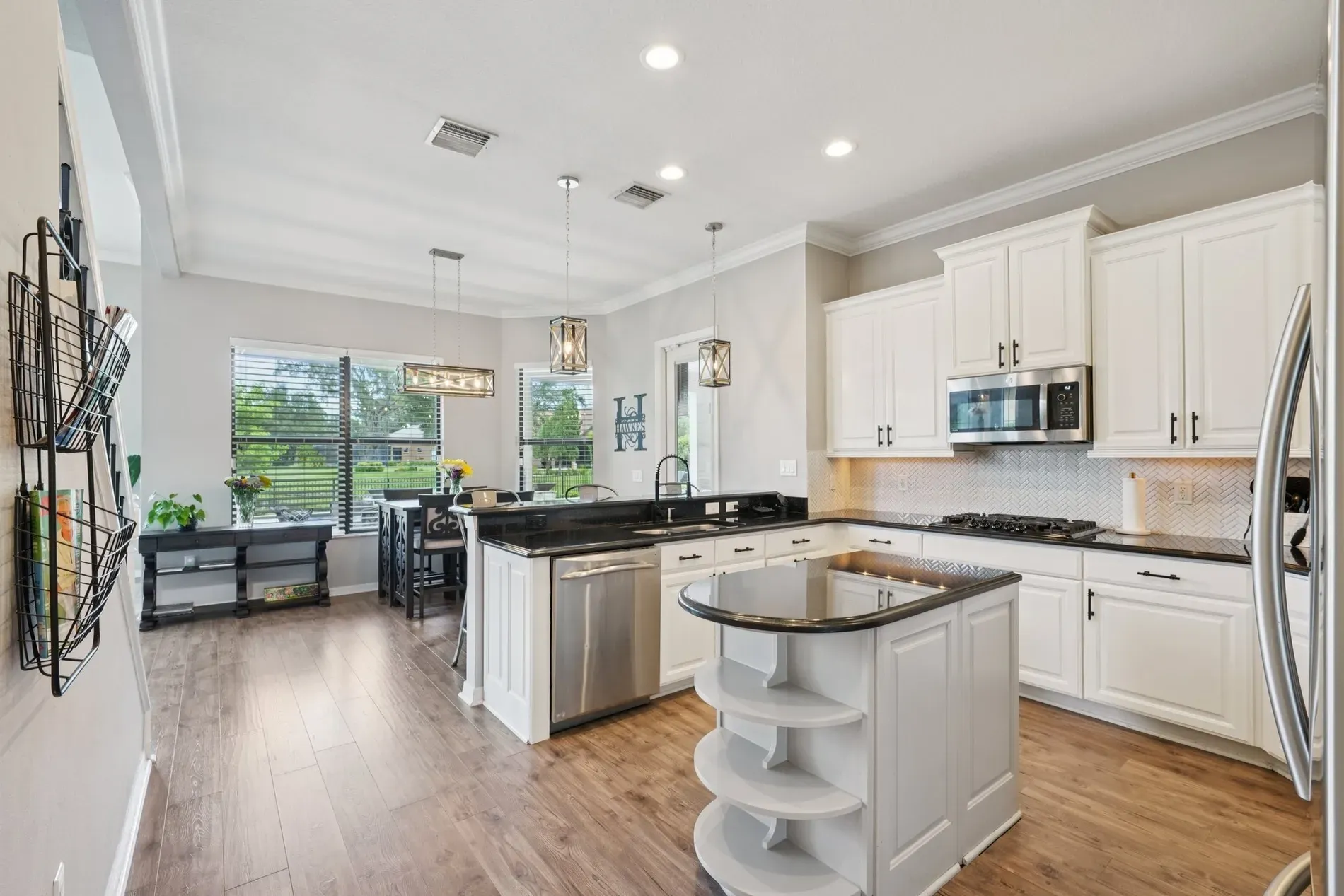 Kitchen time. white cabinets, dark granite, big island. Classic combo, always works.