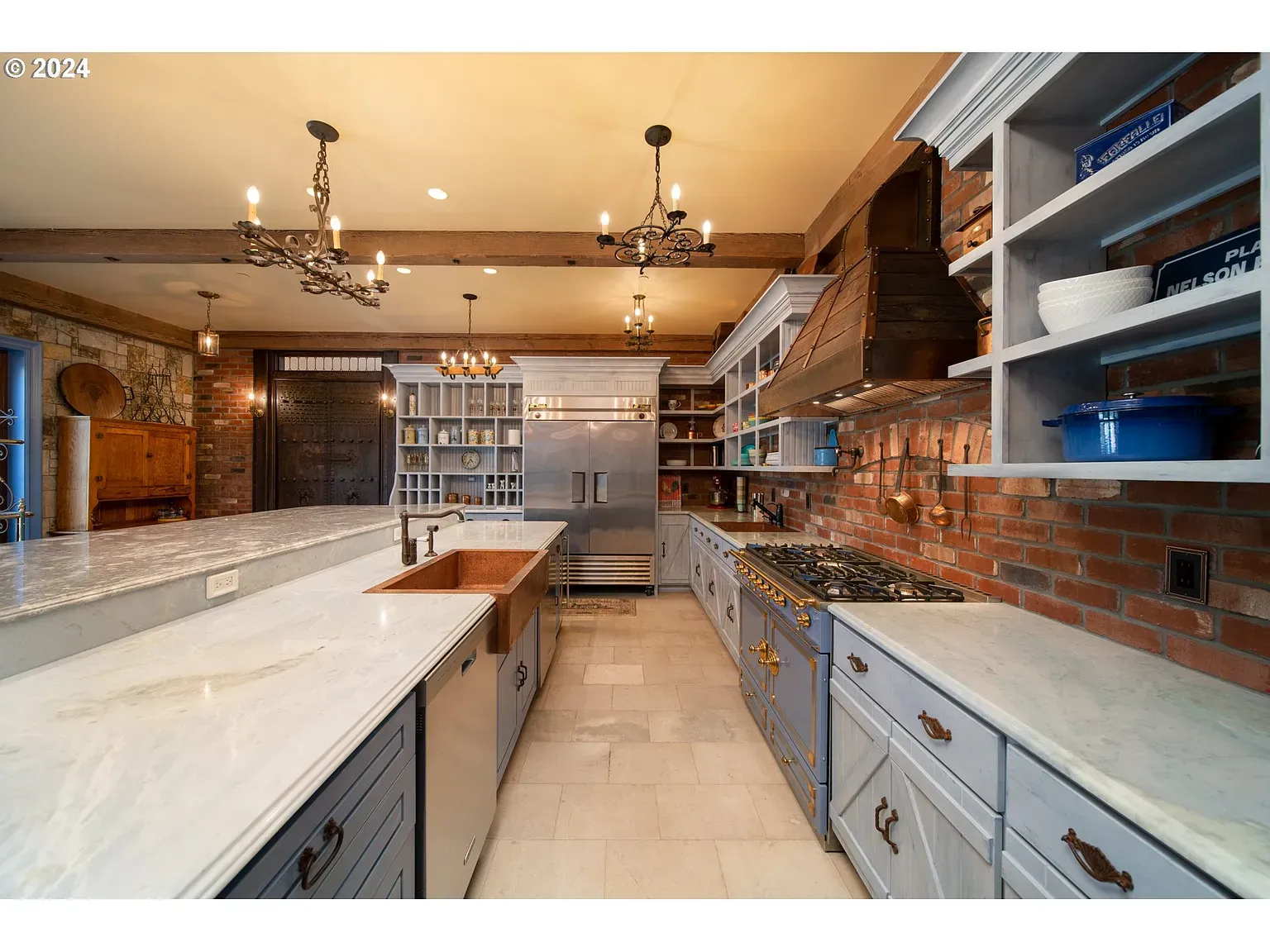 Kitchen with brick walls and marble tops. Not sure, but it lands.