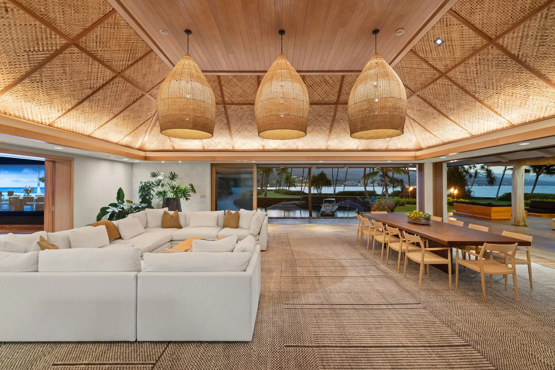 Living area with rattan ceiling. airy, soft tones, doors wide open.