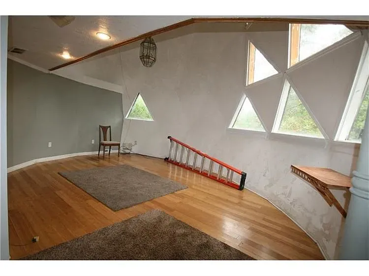 And then triangles everywhere. Huge windows, cream plaster, warm floors. Anyone worried about blinds?