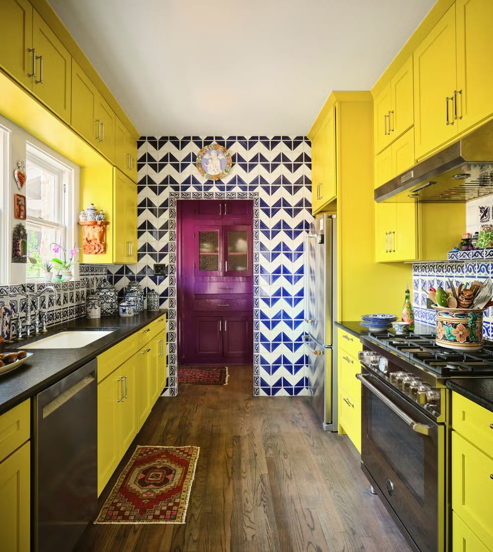 Here's the kitchen—sunflower cabinets, patterned tiles. I mean, it's cheerful chaos.