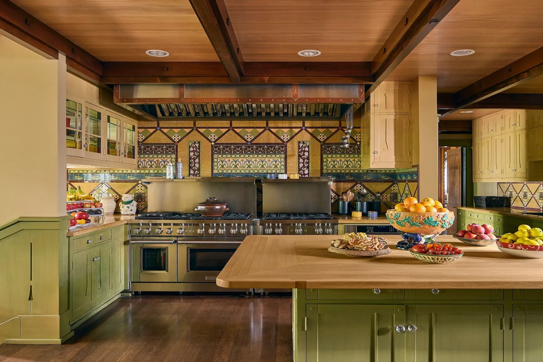 Back to the kitchen—sage cabinets, chunky beams. Not sure about the art tiles.