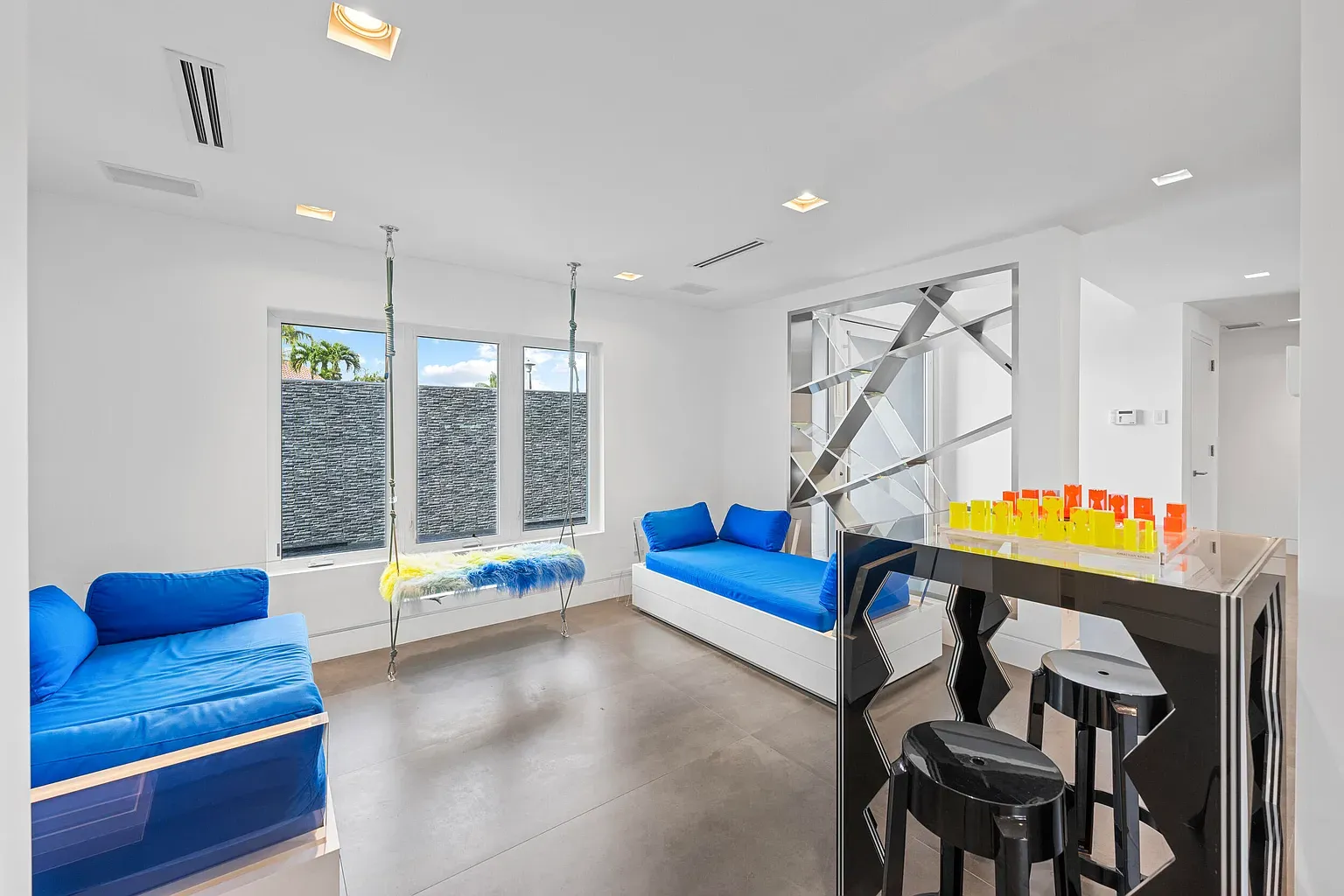 Two blue sofas against all that white. Clean, maybe a touch sterile.