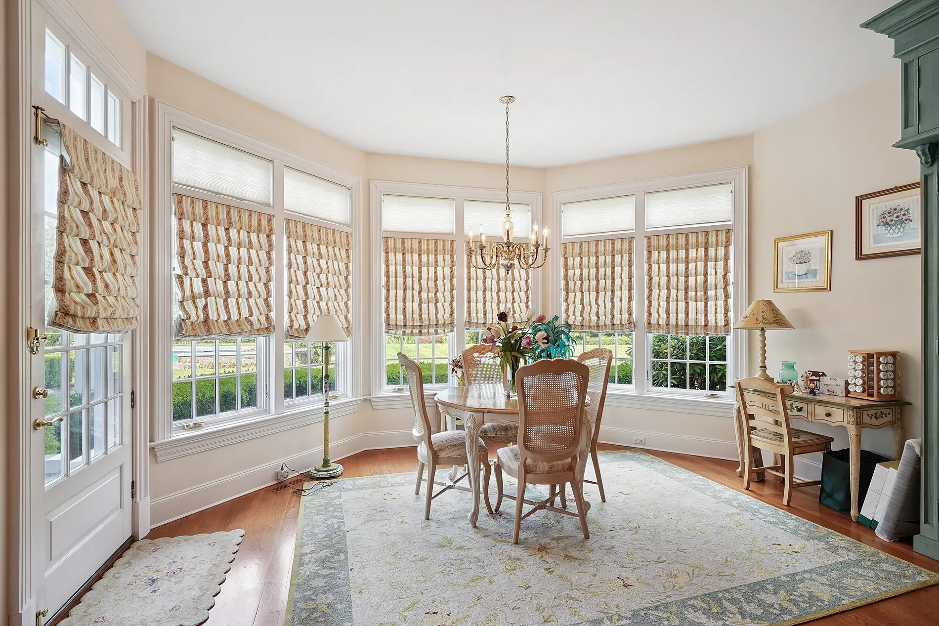 Here’s the dining bay — sun blasting in, soft walls, floaty curtains doing vibes.