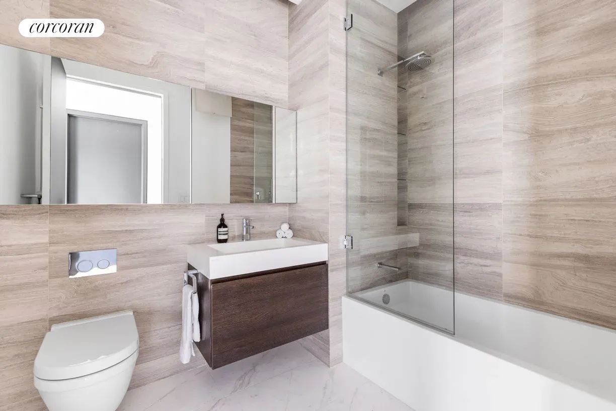 And then a spa-ish bathroom—beige tile, glass shower, rainfall head. Peaceful.