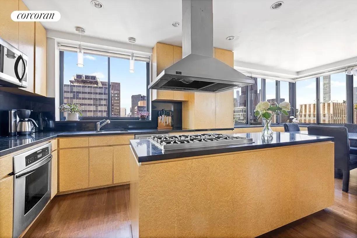 Warm wood, then that black marble island. Anyone paying $4M cooking here nightly?