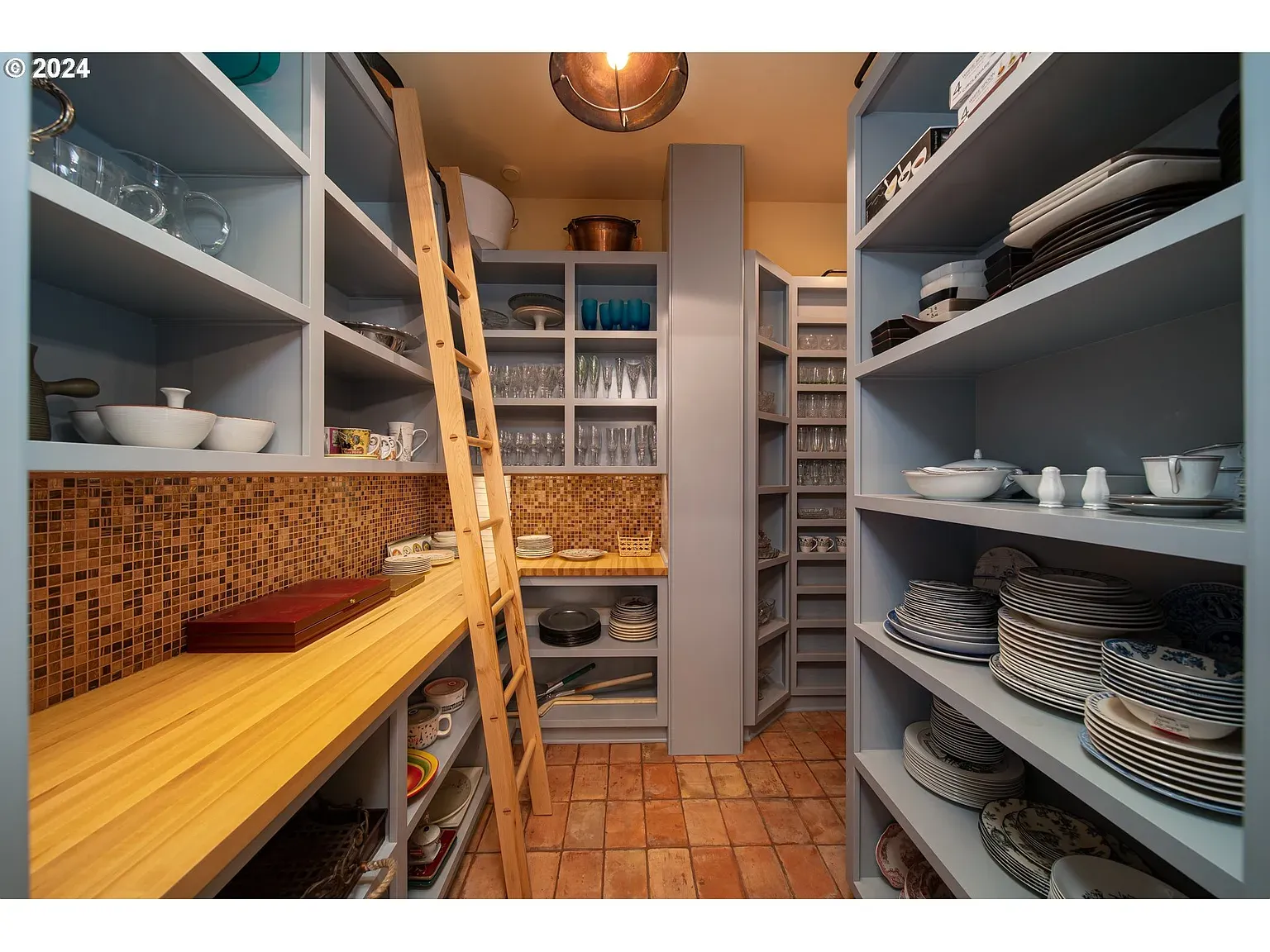 Here’s the pantry—soft blue cabinets, baskets, labels. Honestly therapeutic to look at.
