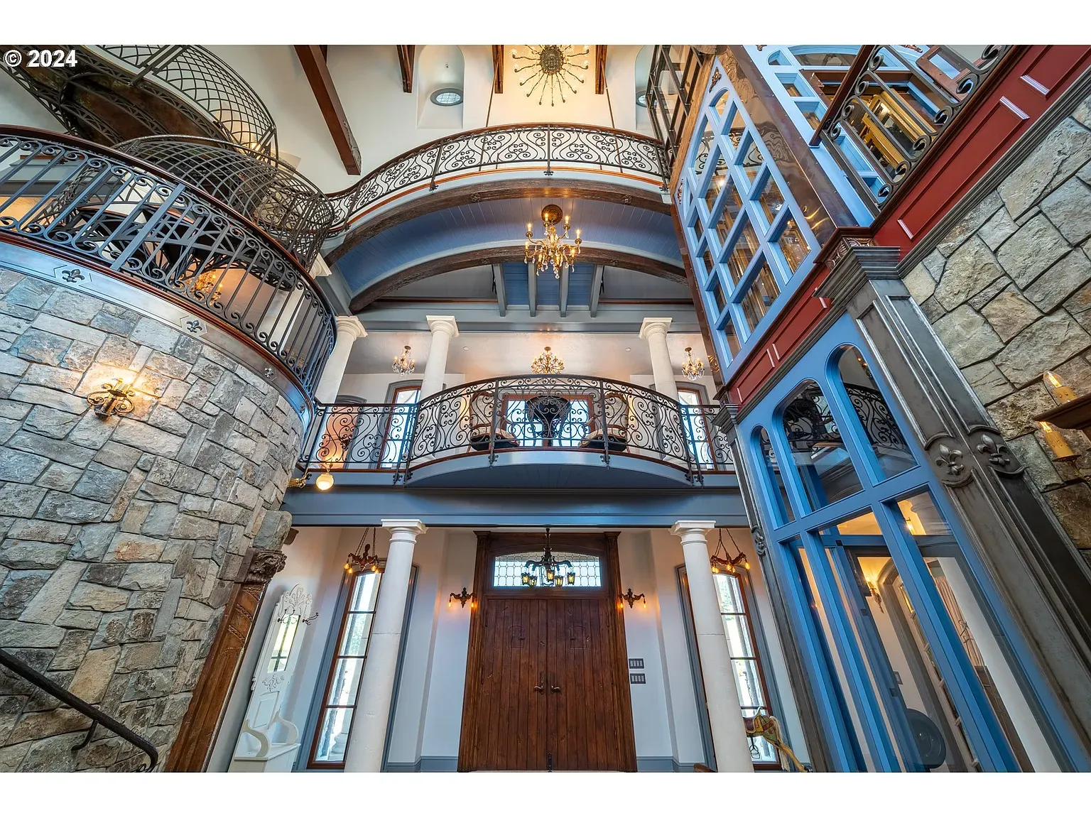 Multi-level entry with a big granite wall. Industrial rails meet mountain house.