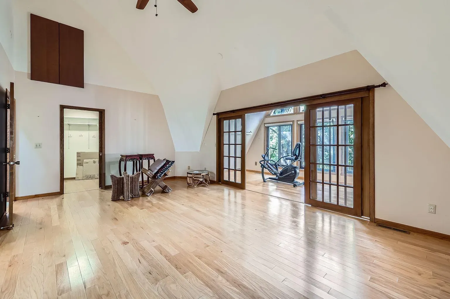 Big open room, light hardwood everywhere. From this angle the floor runs forever.