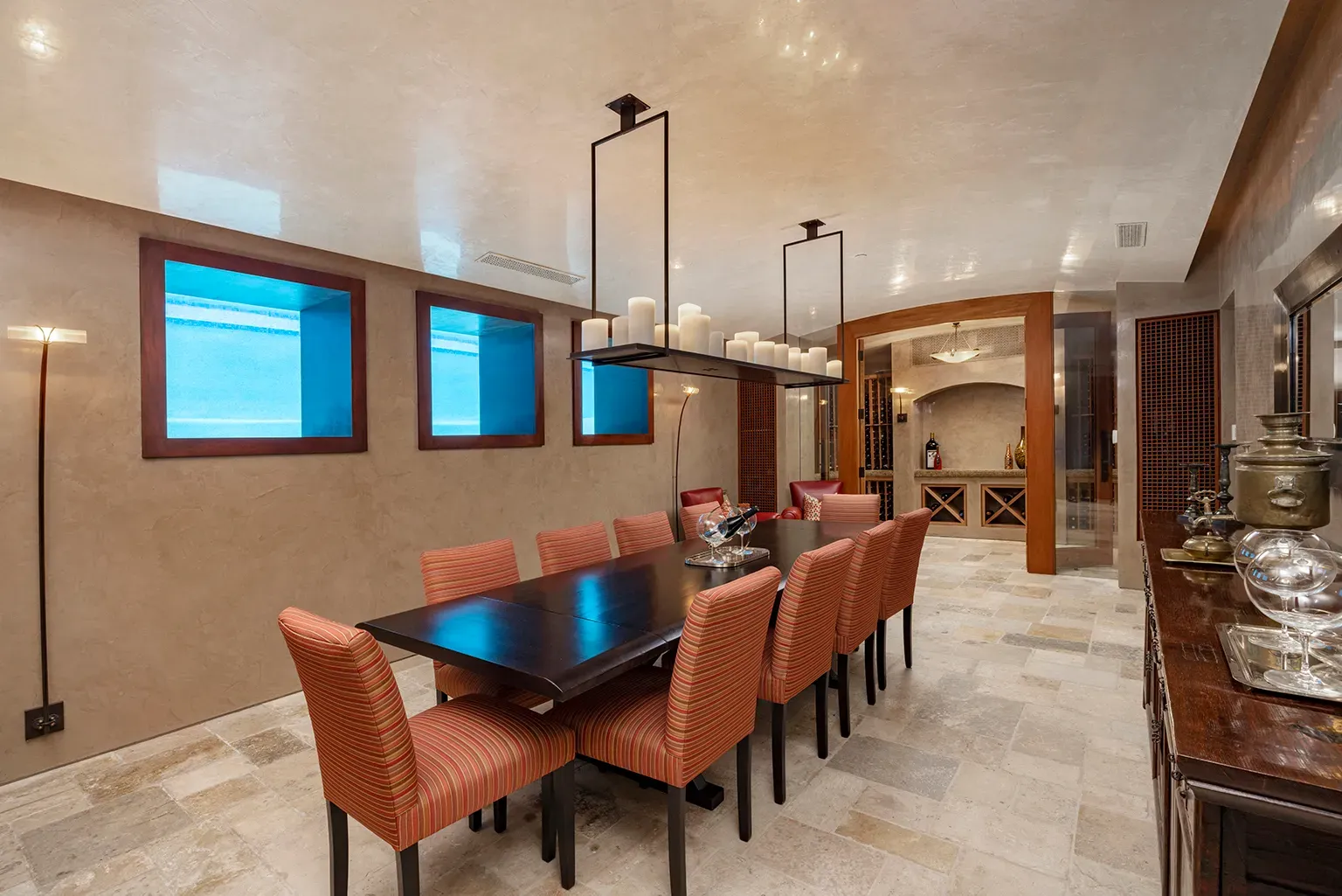 Dining room’s warm beige on stone. Ceiling detail’s doing a lot, maybe too much?