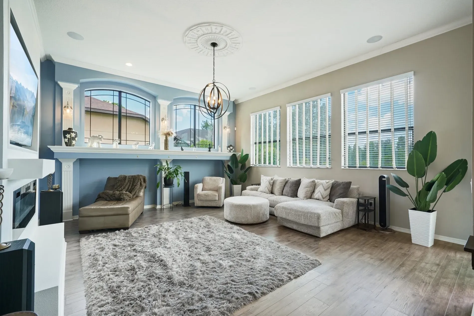 Living room in soft blues and neutrals. from this angle, chandelier shines.