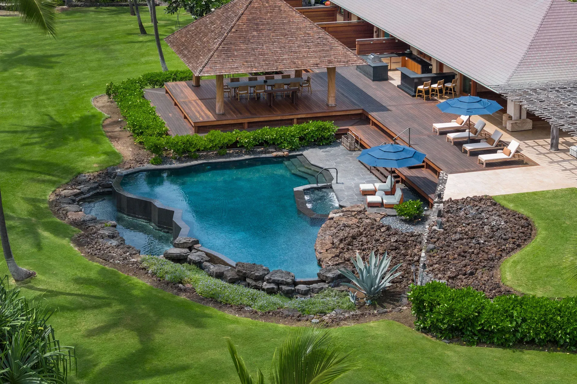 Pool is glassy. natural stone edges, and that curved shelf thing?