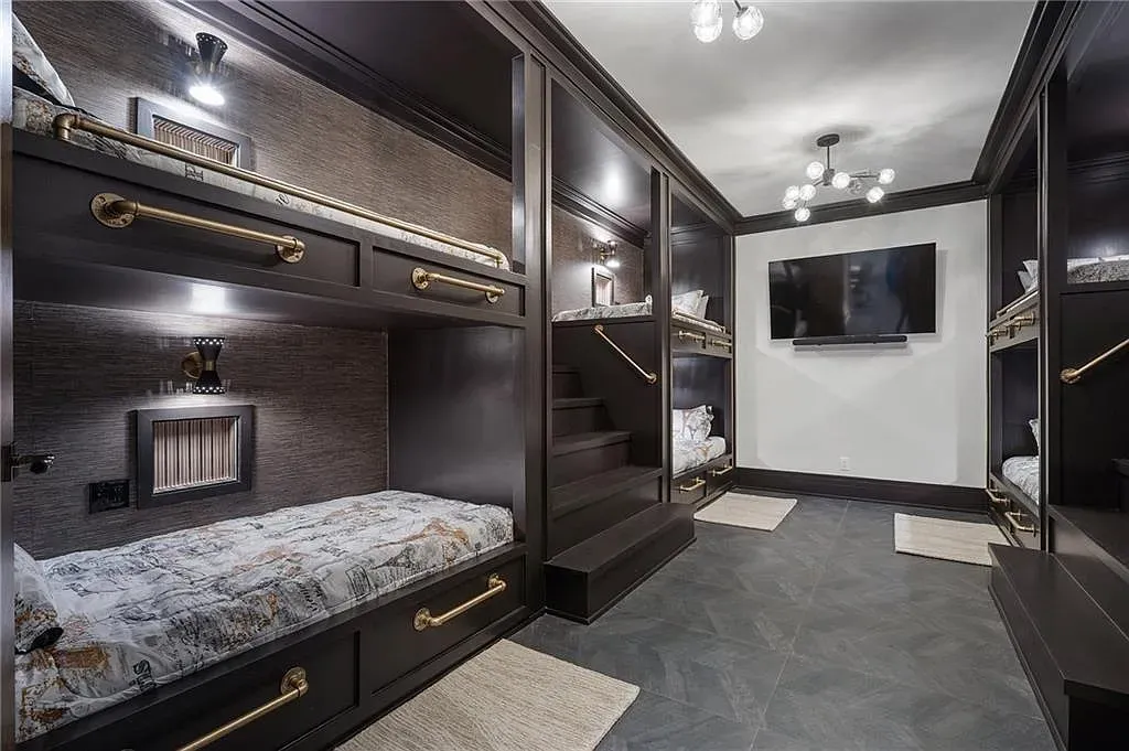 Bunk room goes moody — dark wood, clean lines. Hotel vibes for kids.