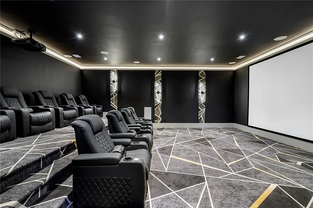 Theater time — tiered recliners, giant screen. Where's the popcorn machine hiding?