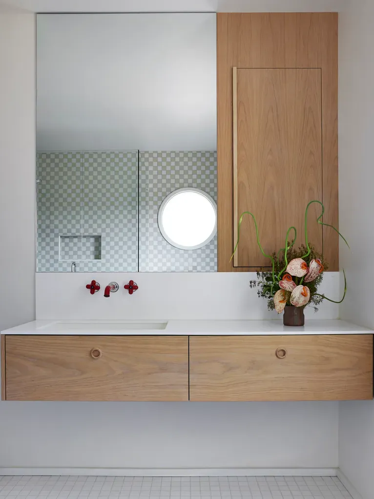 Floating wood vanity looks clean. Hidden drawers, crisp lighting. Anyone know that faucet brand?