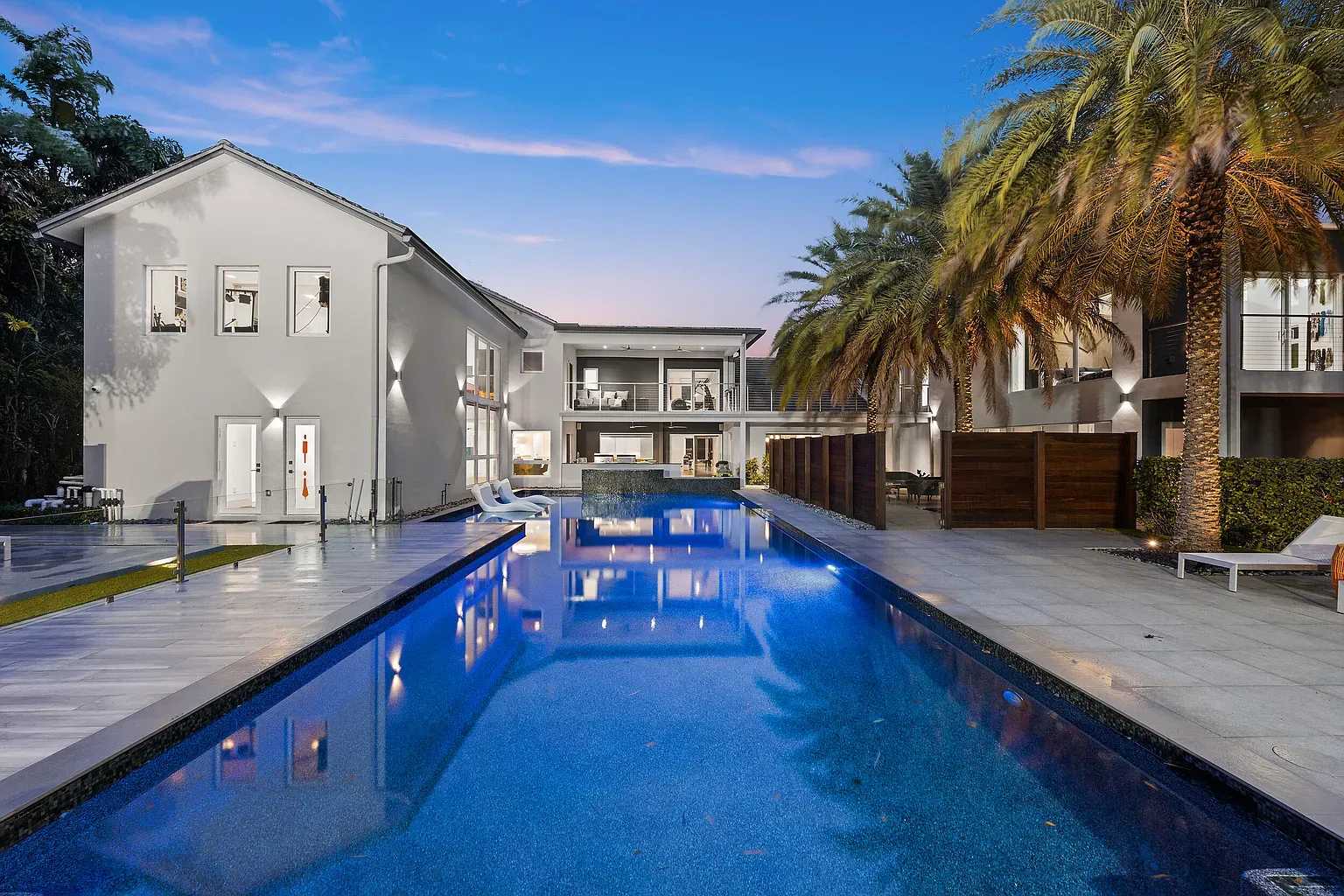 Here's the pool at twilight — glassy water, lavender to deep blue.
