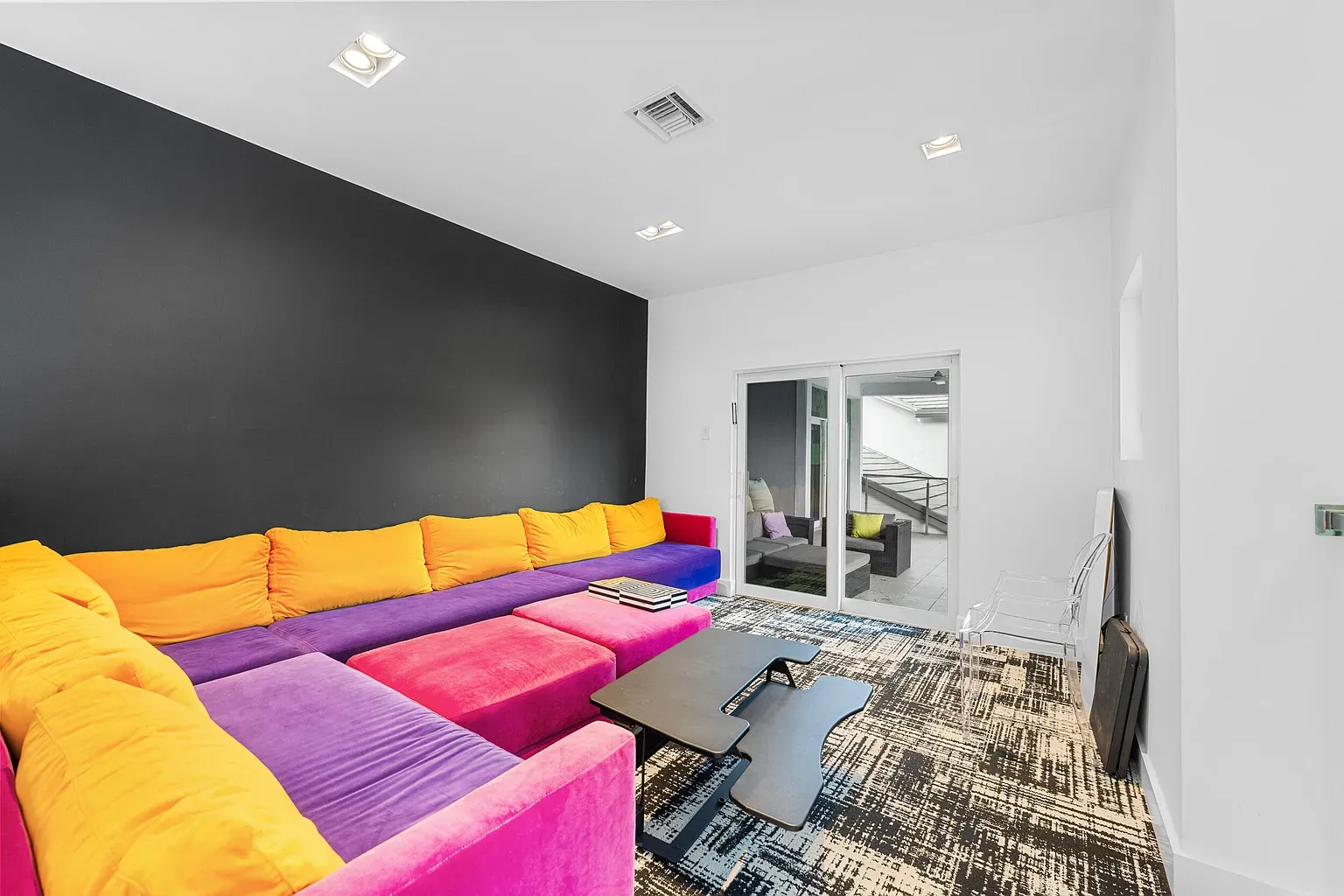 Okay, this sofa is wild—purple, pink, yellow. Fun or chaos?