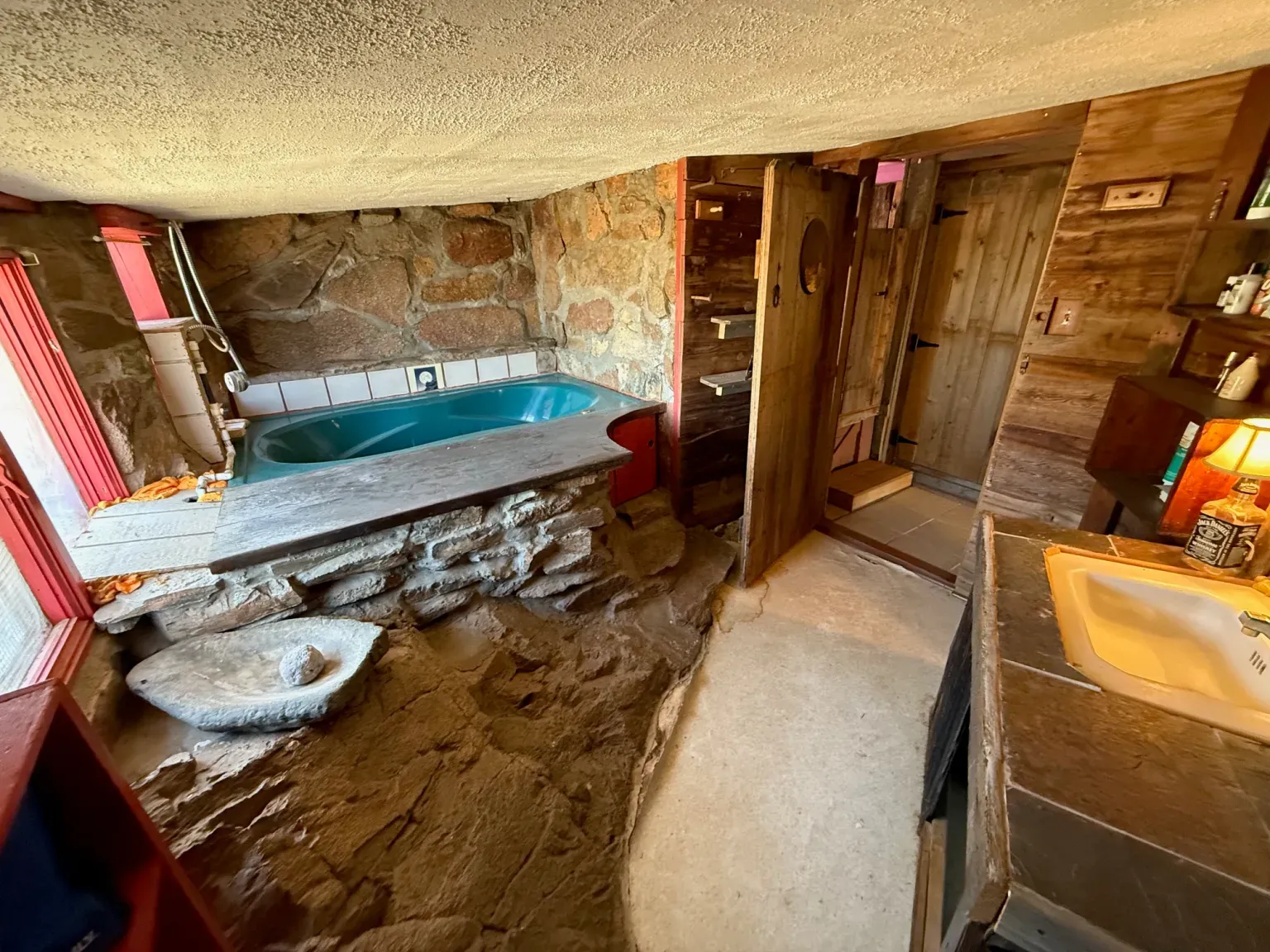 Stone wall in the bathroom is wild, showering in a canyon.