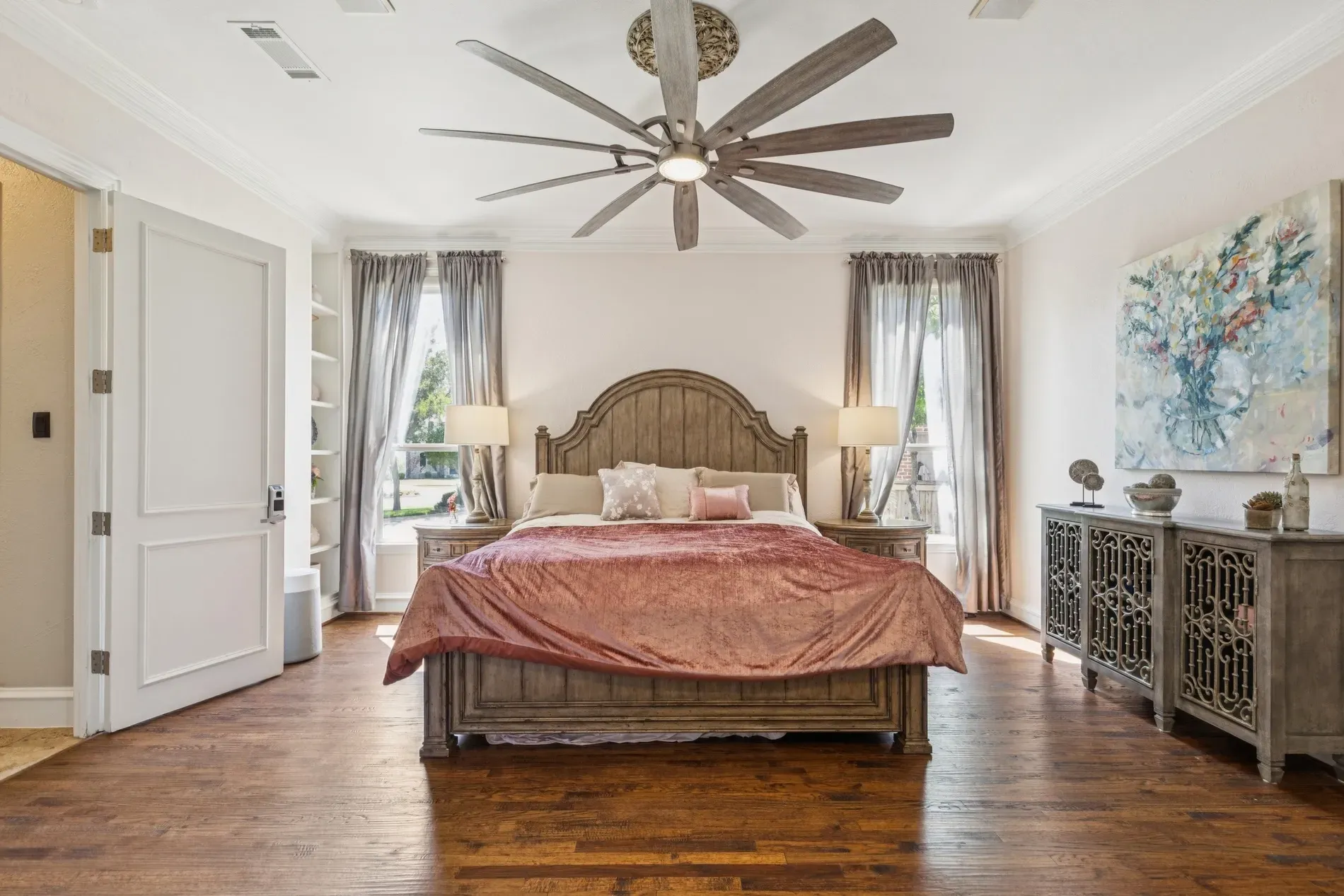 Bedroom feels hotel-level cozy. Big upholstered headboard stealing the show.