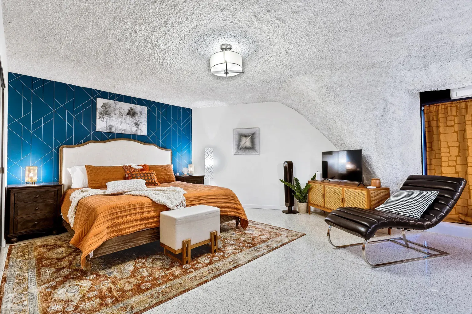 Bedroom goes full cave mode, with a deep accent wall. Cozy.