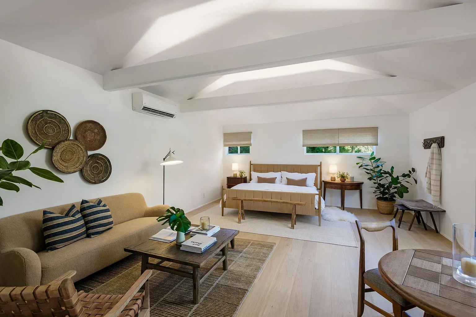 Beams overhead, breezy bedding, a little rustic without going cabin. I’m into it.