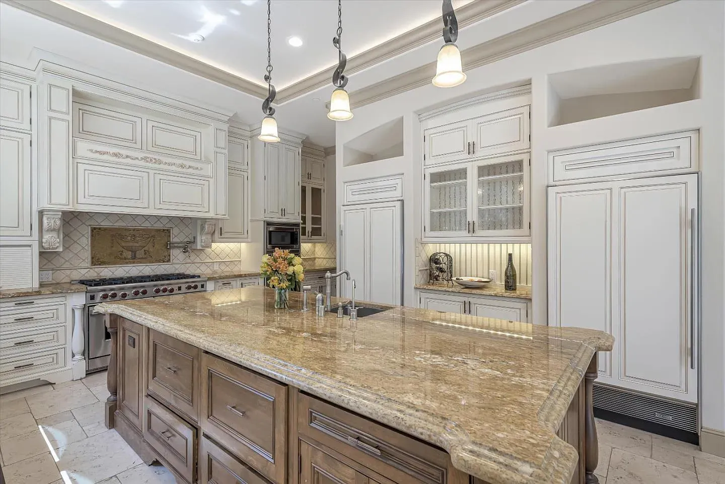 That granite island is massive and shiny. Plenty of room for chaos cooking.