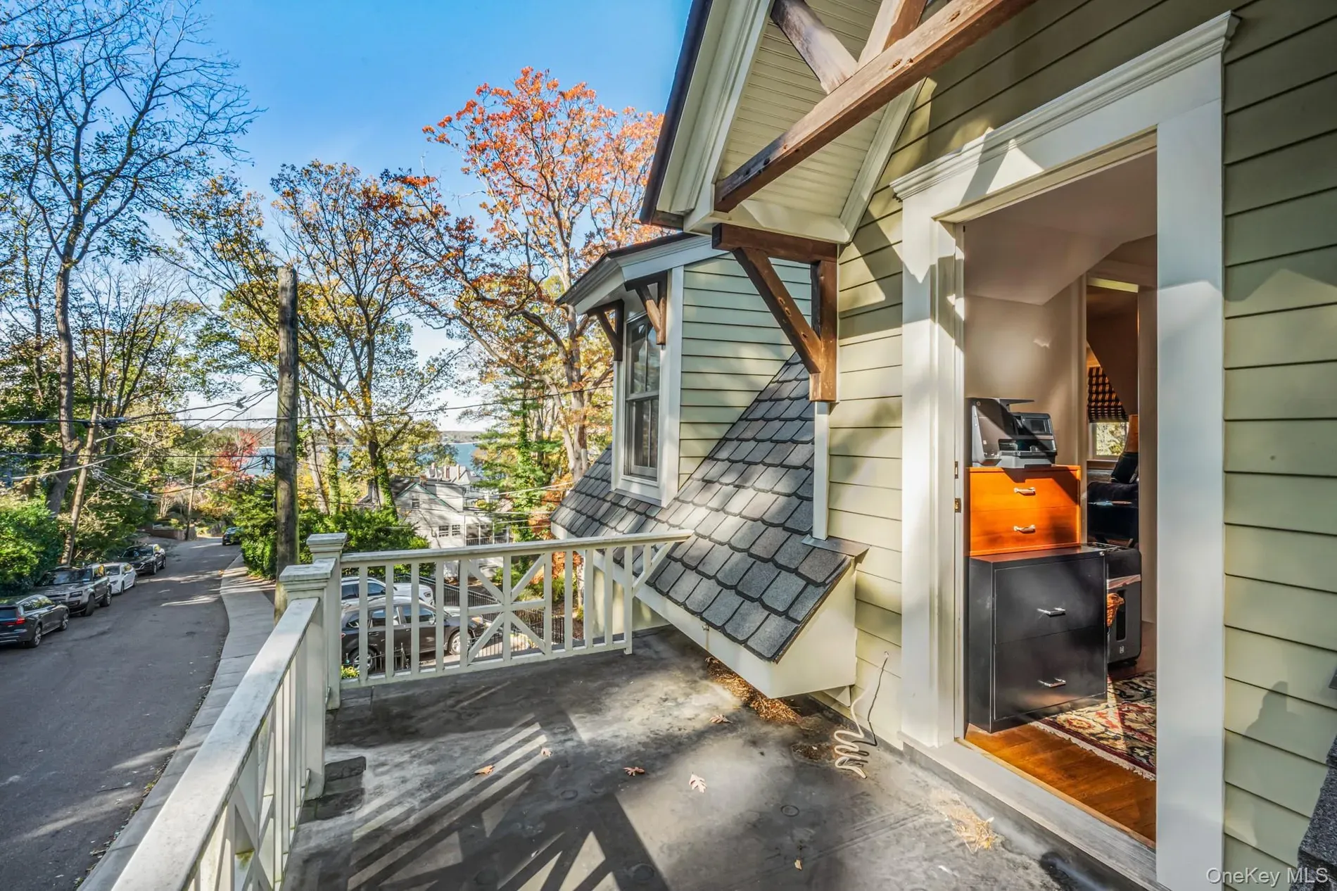 Balcony on the front, pale green and white, cute city view.
