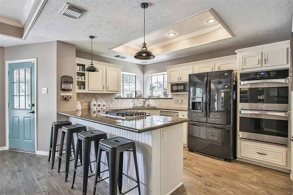 Off-white kitchen cabinets and a coffered ceiling. Clean, bright, quietly fancy.