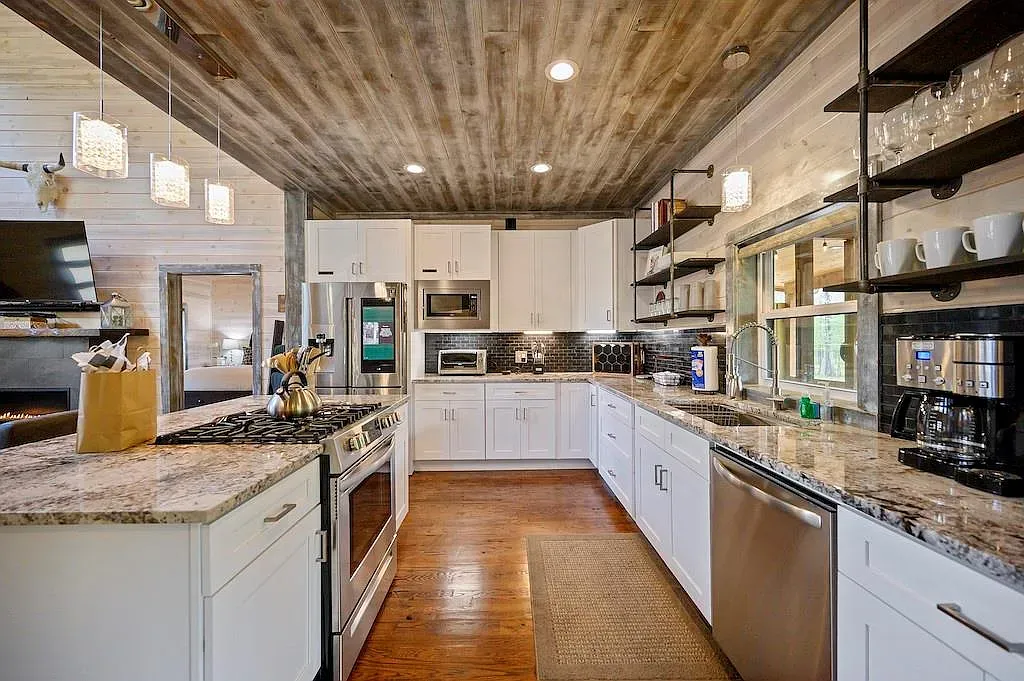 White shaker kitchen, warm floors, rustic ceiling. Clean but still homey.