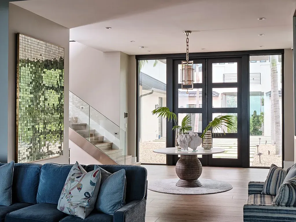 Living room with deep blue sofas. Looks a nap waiting to happen.