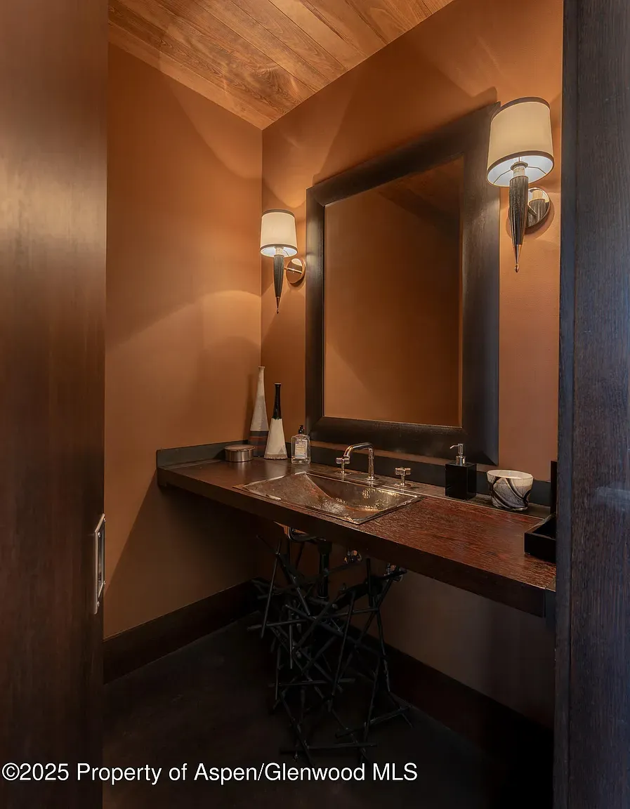 Terracotta powder room feels cozy and modern. Small space, big attitude.