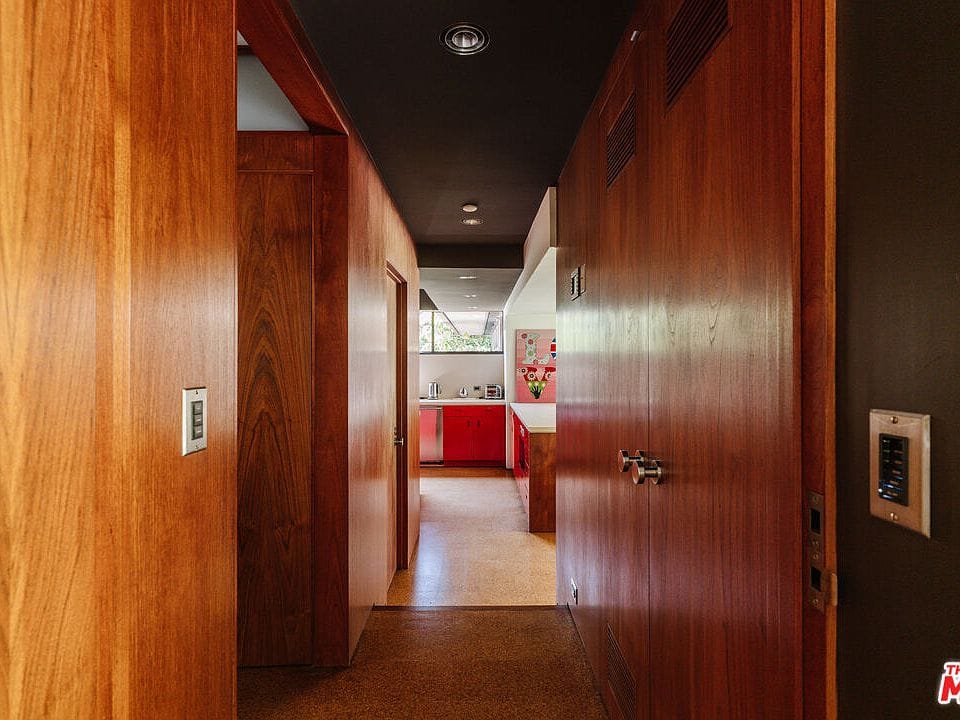 Moody hallway. Wood wraps everything and the ceiling goes charcoal.